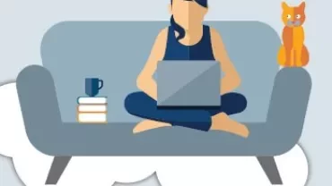 Person sitting on a couch with a laptop, books, a cup, and a cat.