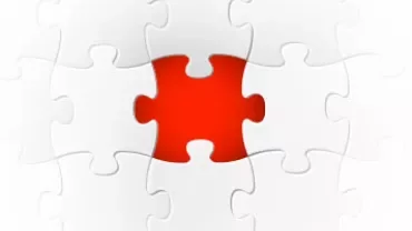A red puzzle piece among white pieces.