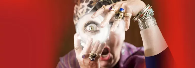 Person with jewelry holds hand over face with magnifying lens.