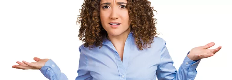 Person shrugging wearing a blue shirt with a confused expression
