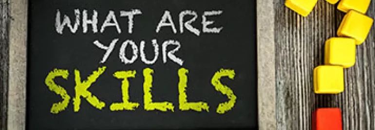 Chalkboard with 'What are your skills?' written on it, next to colored blocks forming a question mark.